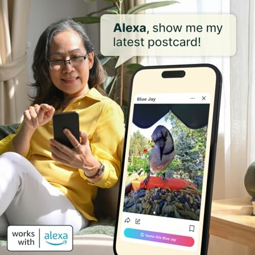 Woman using Alexa to view a postcard on her smartphone.