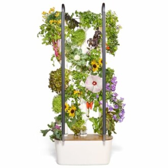 Indoor vertical garden planter with various plants and flowers.